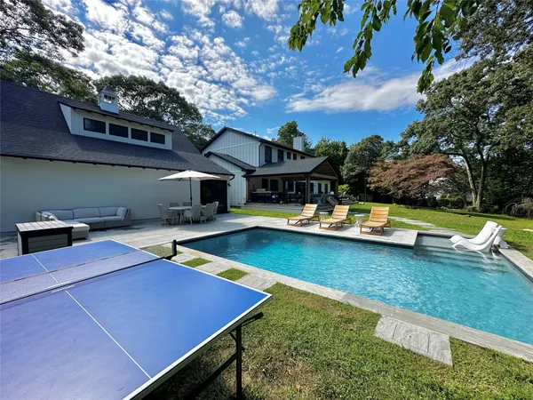 a view of a swimming pool with lounge chairs