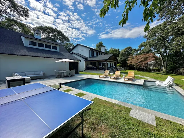 a view of a swimming pool with lounge chairs