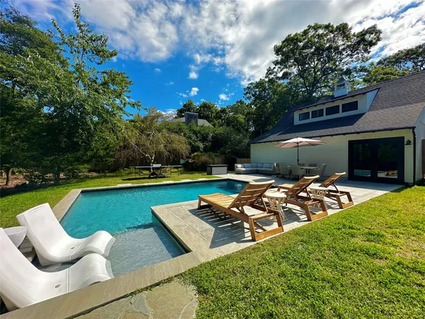a view of a swimming pool with lounge chairs