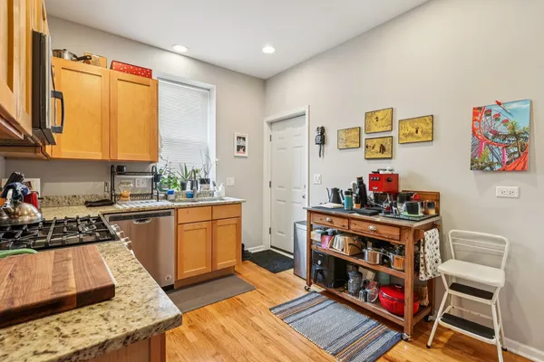 a kitchen with stainless steel appliances a stove a sink and a refrigerator