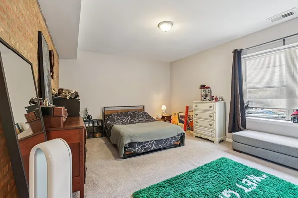 a bedroom with furniture and a large window