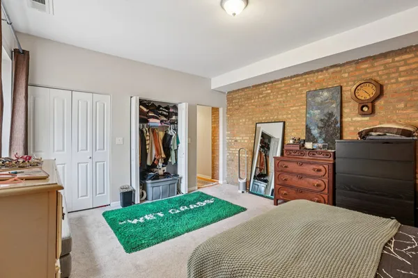 a bedroom with a bed and a dresser