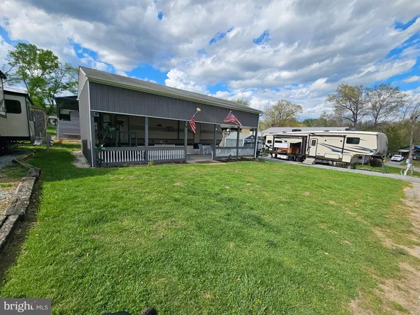 a view of a house with a yard and sitting area