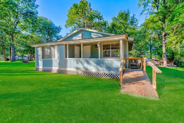 a front view of house with yard and green space