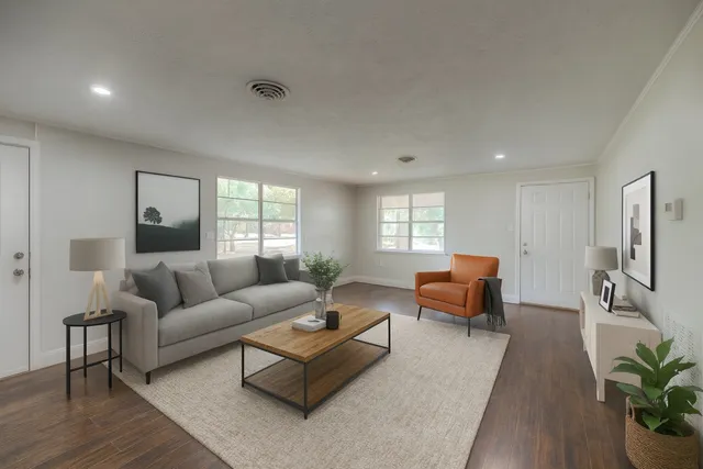 a living room with furniture and wooden floor