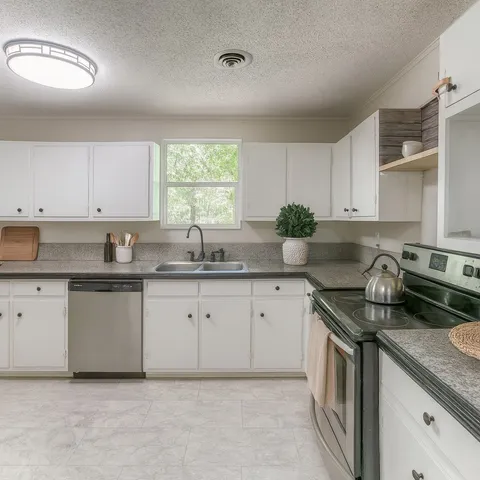 a kitchen that has a sink and a stove