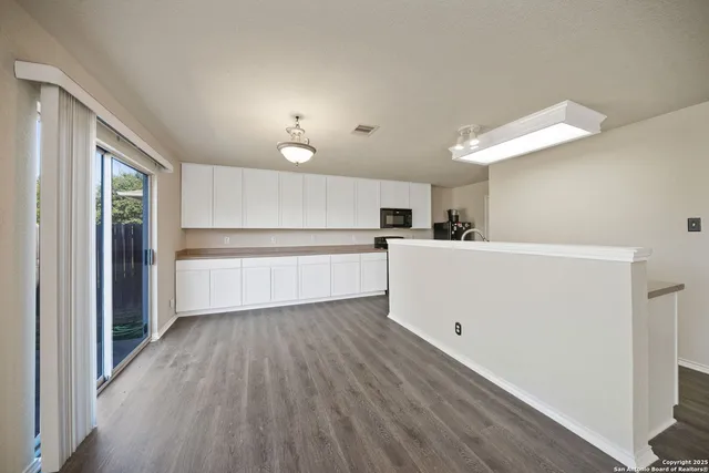 a view of a kitchen with a sink and a refrigerator