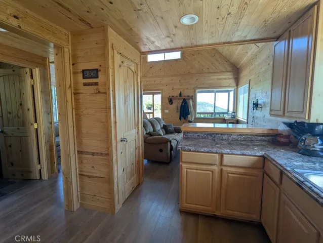 a spacious bathroom with a granite countertop sink a mirror and shower