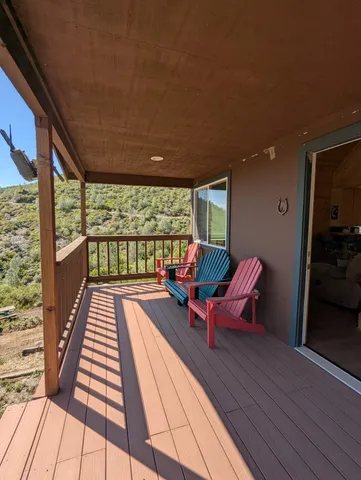 a balcony with wooden benches and furniture