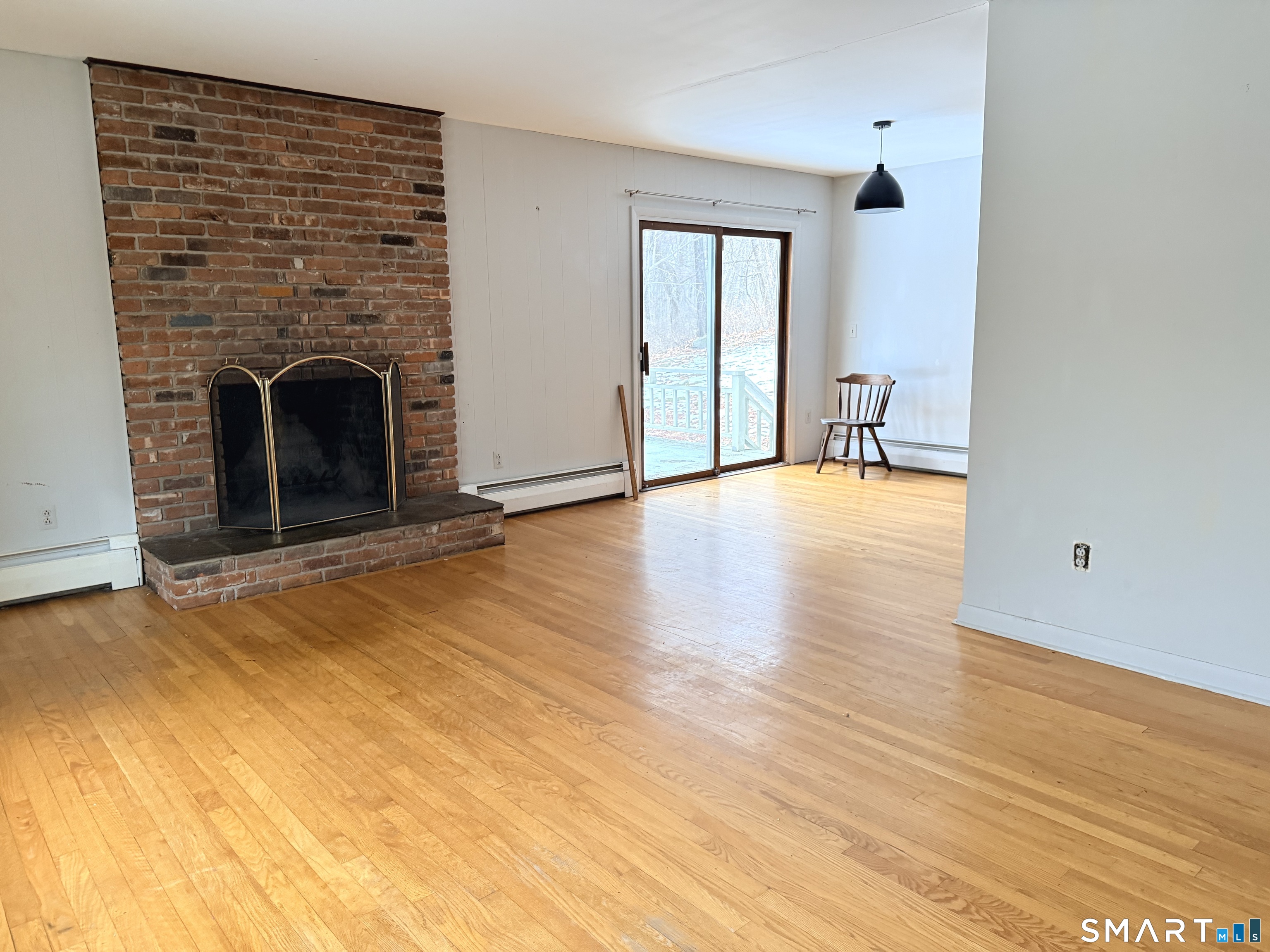 146 Scribner Hill Road Wilton, CT 06897 - Photo 3 of 13 a view of empty room with wooden floor and fireplace