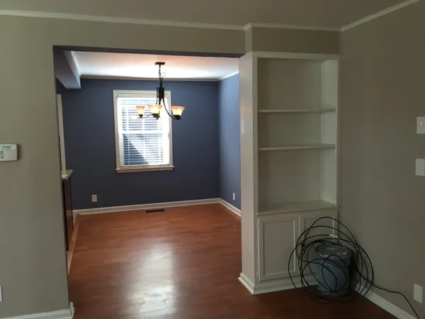 a room with window walk in closet and wooden floor