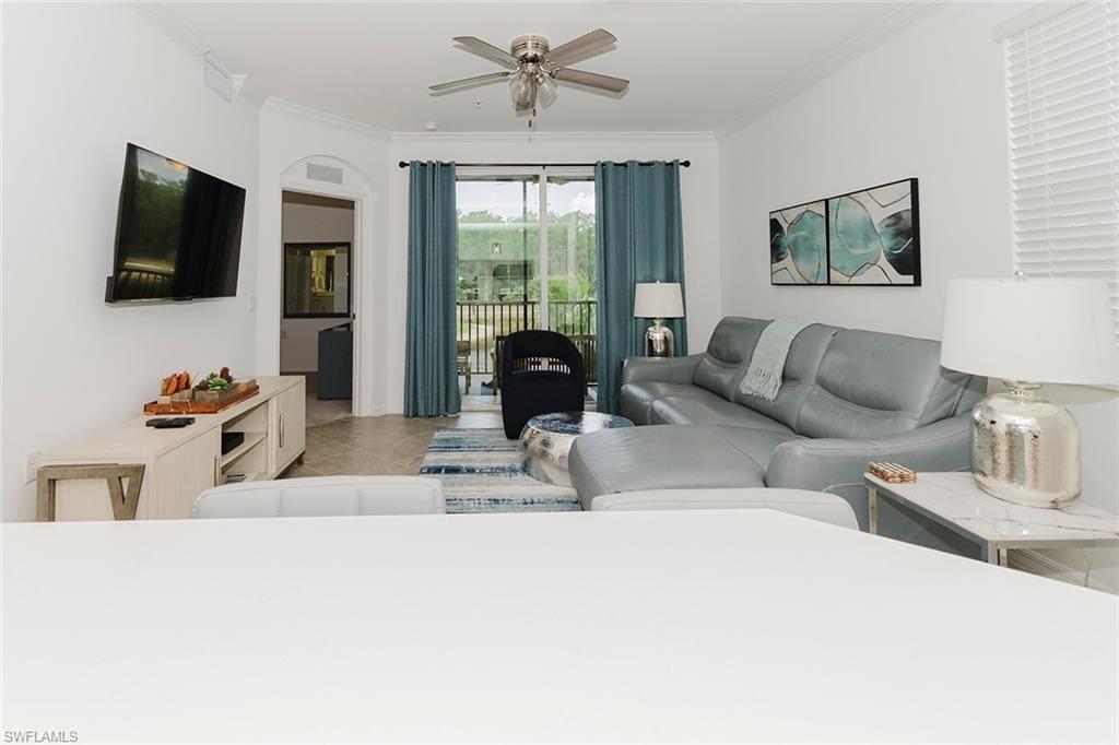 6034 National Boulevard, Unit 528 Ave Maria, FL 34142 - Photo 11 of 43 a living room with furniture and a flat screen tv