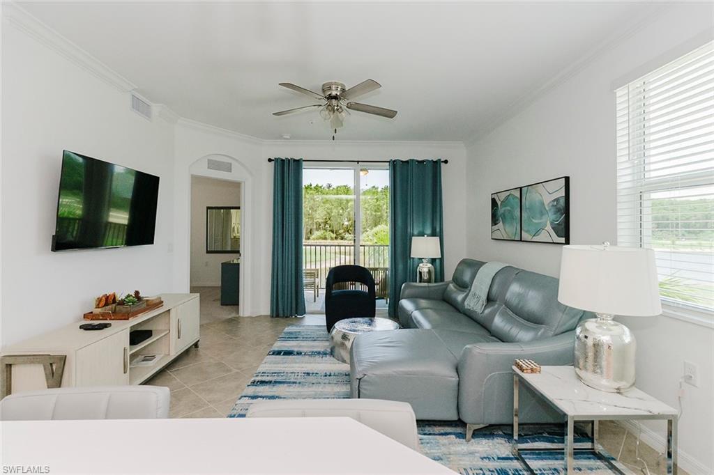 6034 National Boulevard, Unit 528 Ave Maria, FL 34142 - Photo 14 of 43 a living room with furniture fireplace and a flat screen tv
