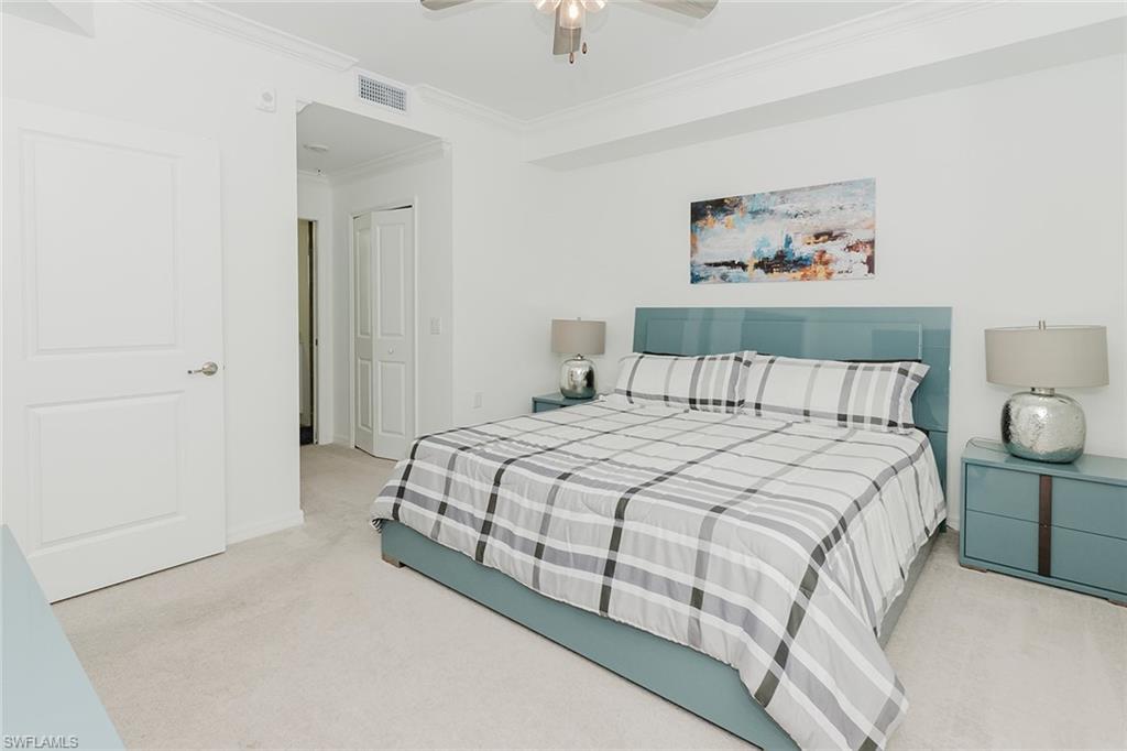 6034 National Boulevard, Unit 528 Ave Maria, FL 34142 - Photo 15 of 43 a bedroom with a bed and painting on the wall