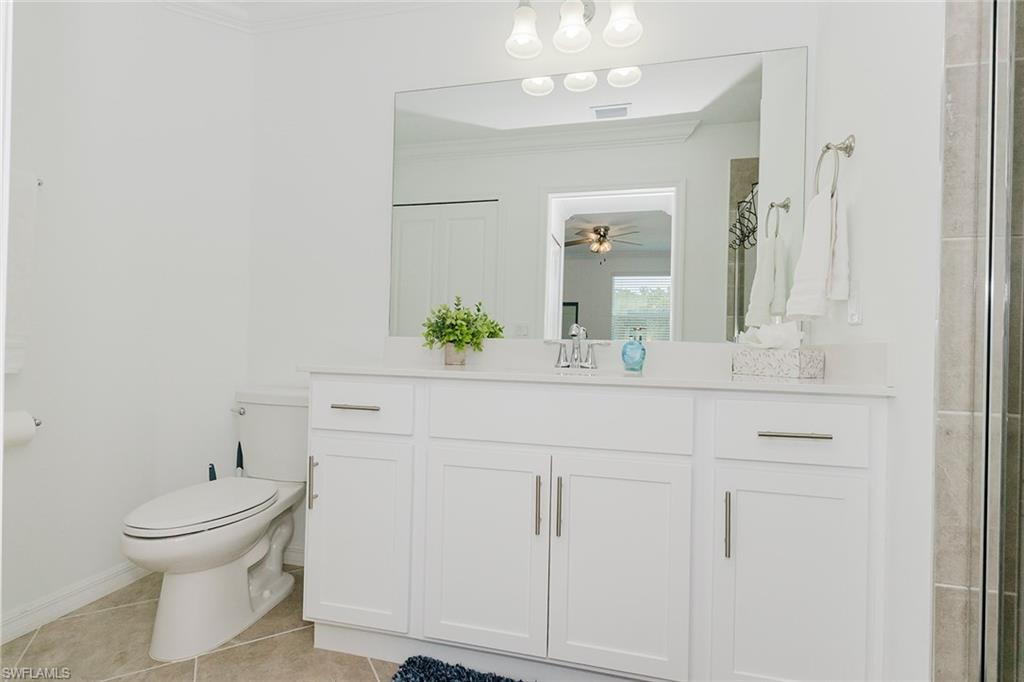 6034 National Boulevard, Unit 528 Ave Maria, FL 34142 - Photo 21 of 43 a bathroom with a sink and a mirror