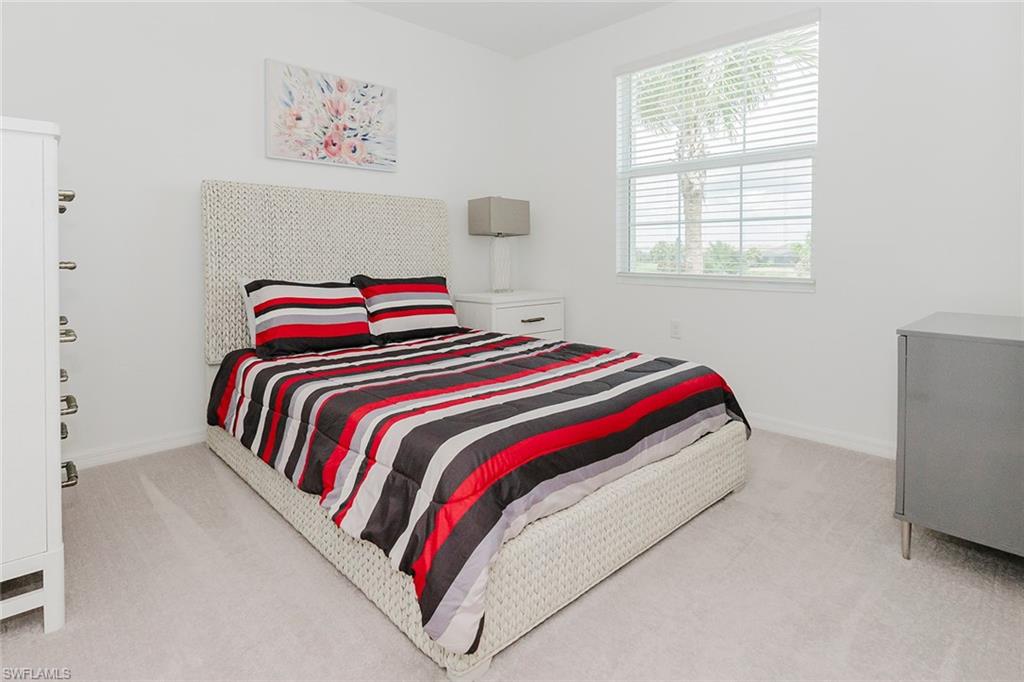 6034 National Boulevard, Unit 528 Ave Maria, FL 34142 - Photo 22 of 43 a bedroom with a bed and a window