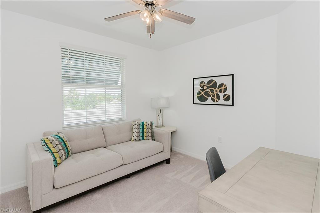6034 National Boulevard, Unit 528 Ave Maria, FL 34142 - Photo 24 of 43 a living room with furniture and a window