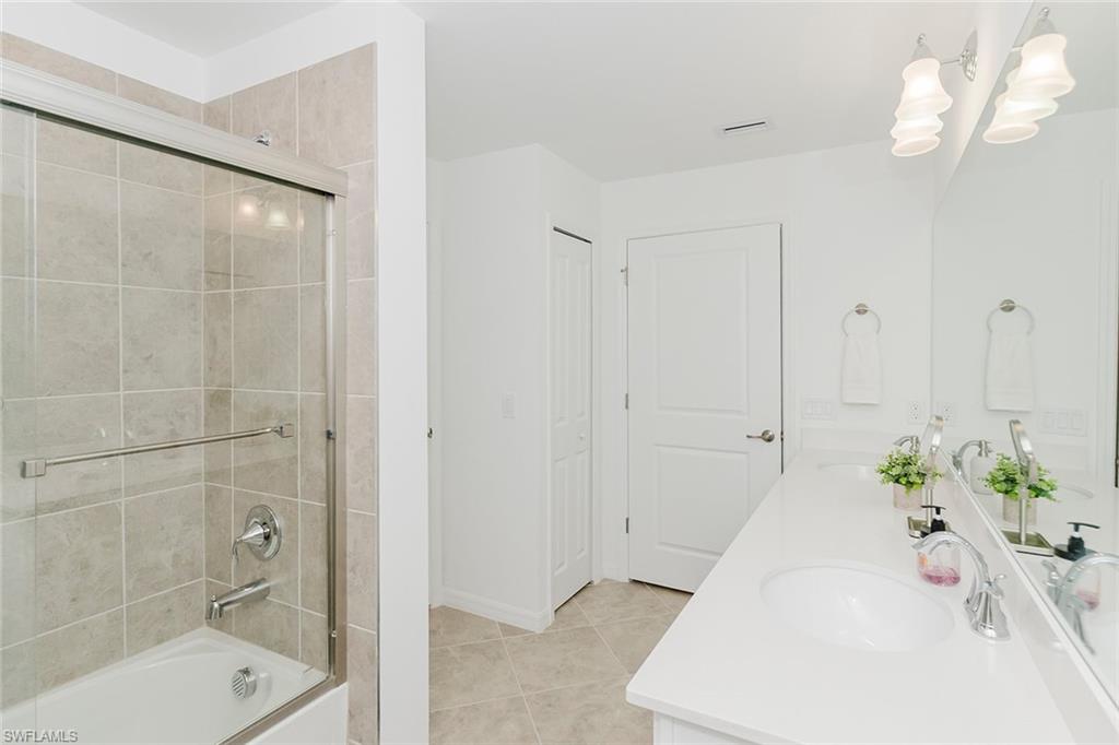 6034 National Boulevard, Unit 528 Ave Maria, FL 34142 - Photo 28 of 43 a bathroom with a bathtub and a shower