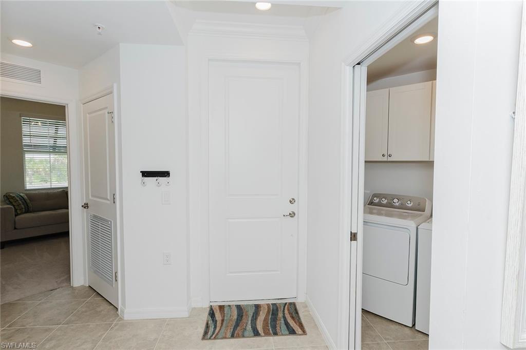 6034 National Boulevard, Unit 528 Ave Maria, FL 34142 - Photo 29 of 43 a view of a kitchen from the hallway