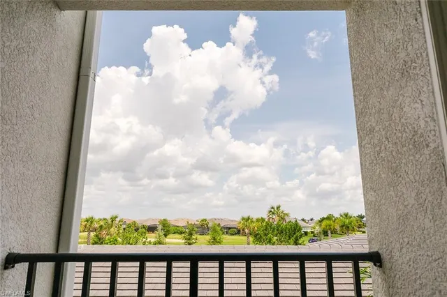 a view of a park with a palm trees