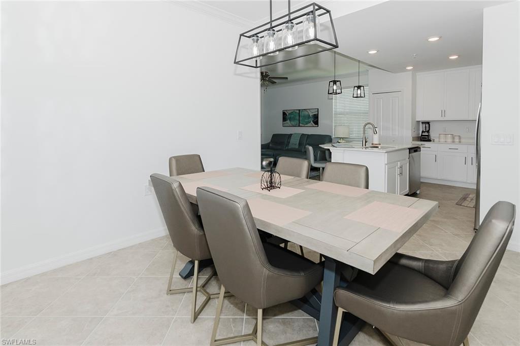 6034 National Boulevard, Unit 528 Ave Maria, FL 34142 - Photo 6 of 43 a view of a dining room with furniture and wooden floor