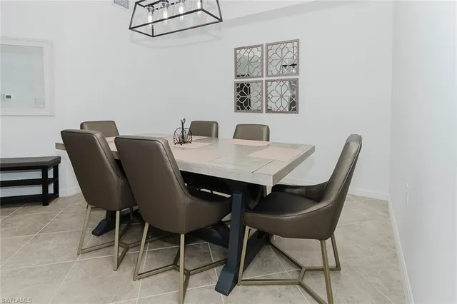 a view of a dining room that has a table and chairs in it