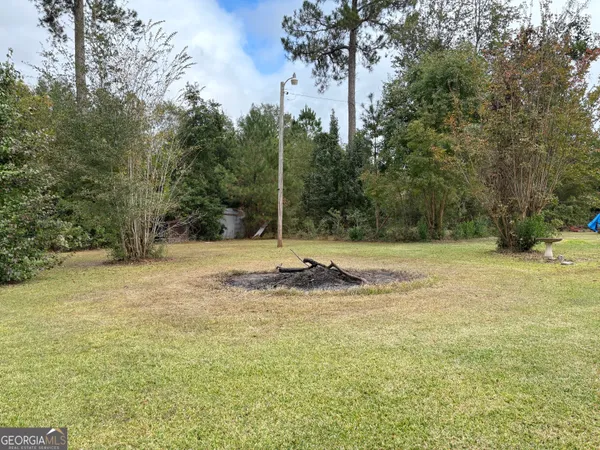 a view of a yard with a tree