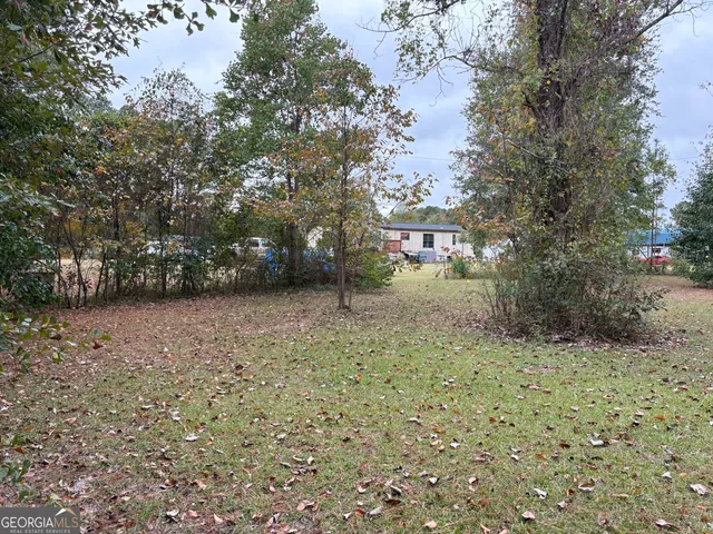 a backyard of a house with lots of green space