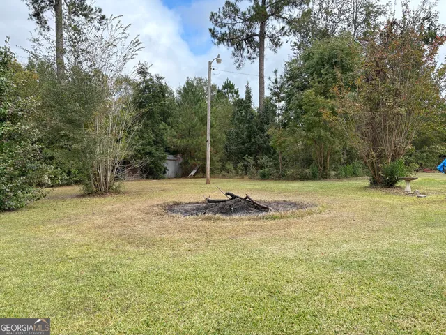 a view of a yard with a tree