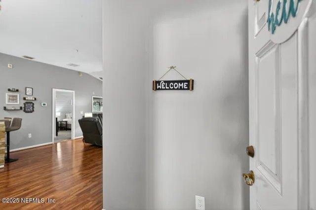a view of a dining room with furniture wooden floor and a chandelier