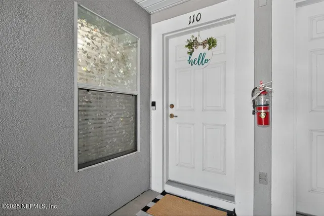 a view of a hallway with wooden floor and a dining room
