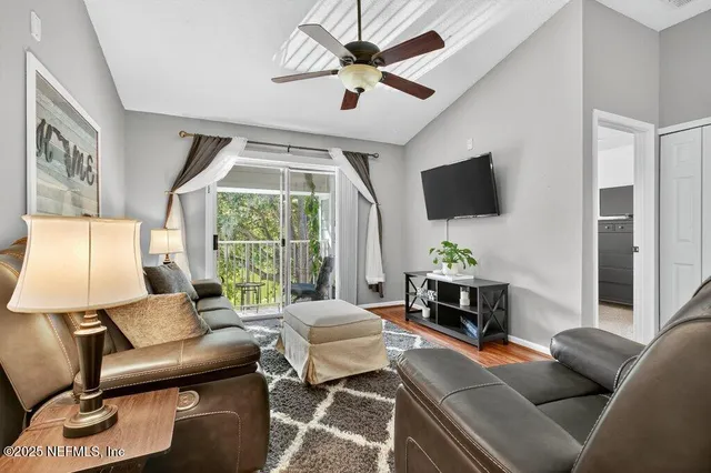 a living room with furniture and a flat screen tv