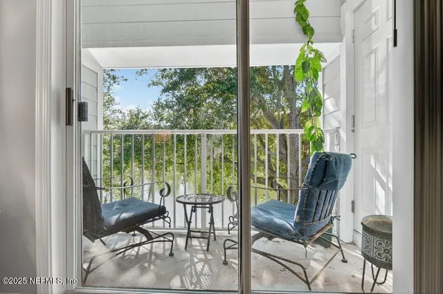 a living room with furniture a flat screen tv and a large window