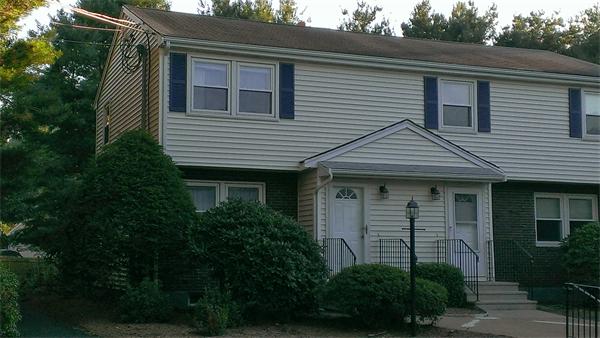 145 Burt Street, Unit 1 Norton, MA 02766 - Photo 2 of 10 a front view of a house with plants