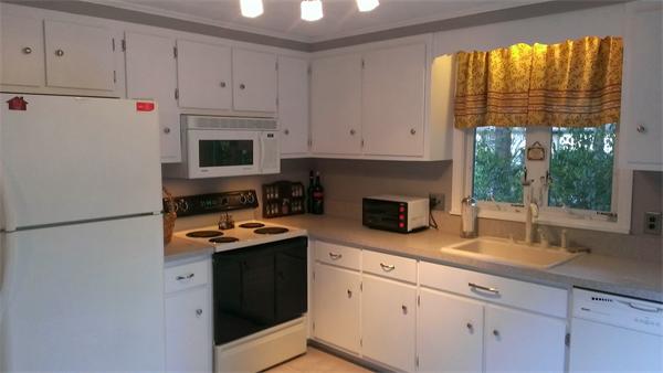 145 Burt Street, Unit 1 Norton, MA 02766 - Photo 4 of 10 a kitchen with granite countertop white cabinets and white appliances