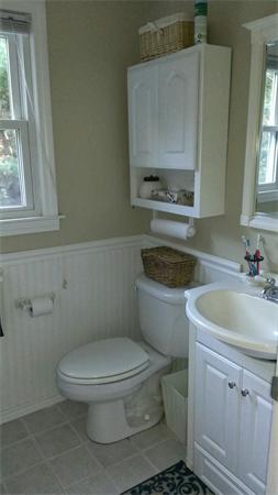 145 Burt Street, Unit 1 Norton, MA 02766 - Photo 5 of 10 a white toilet sitting next to a bathroom sink