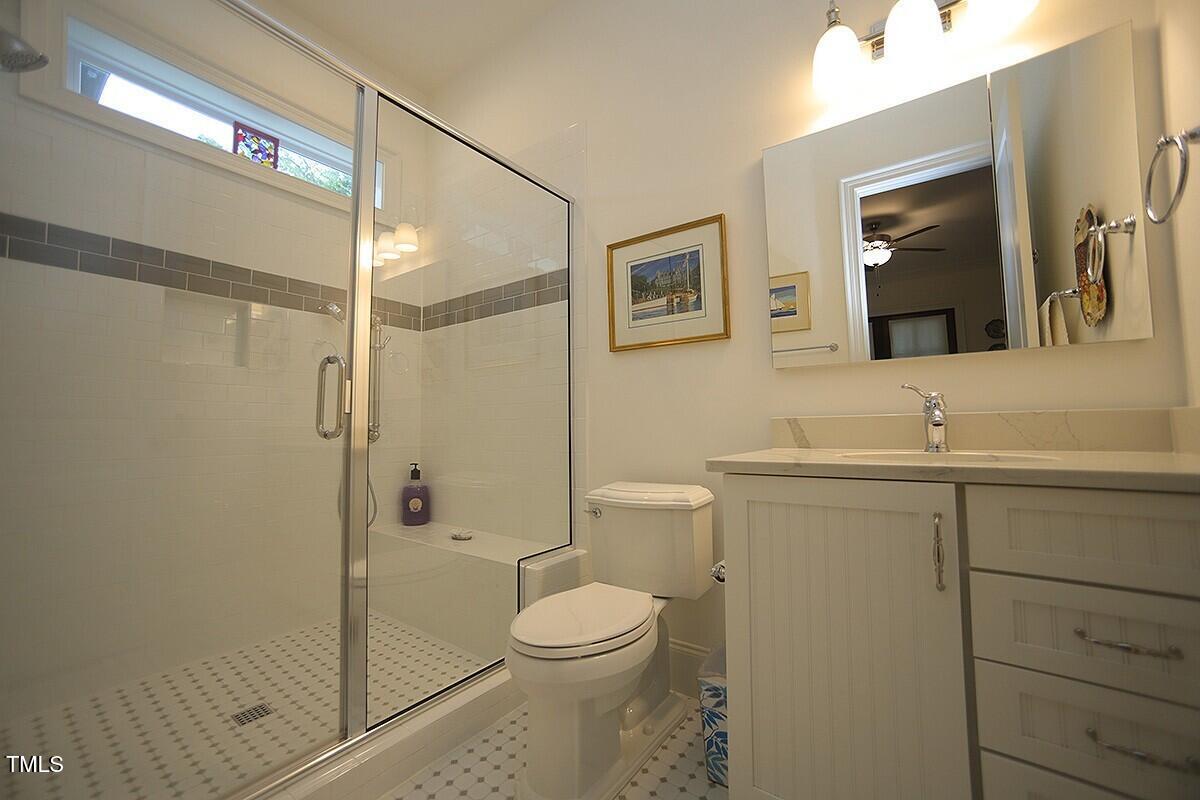 615 Sampson Street Raleigh, NC 27609 - Photo 21 of 26 a bathroom with a toilet a sink and shower