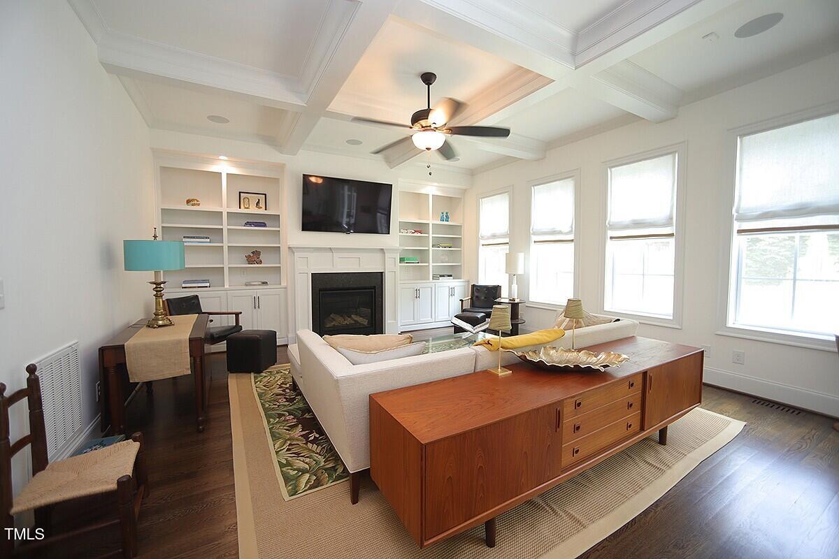 615 Sampson Street Raleigh, NC 27609 - Photo 5 of 26 a living room with furniture fireplace and a flat screen tv