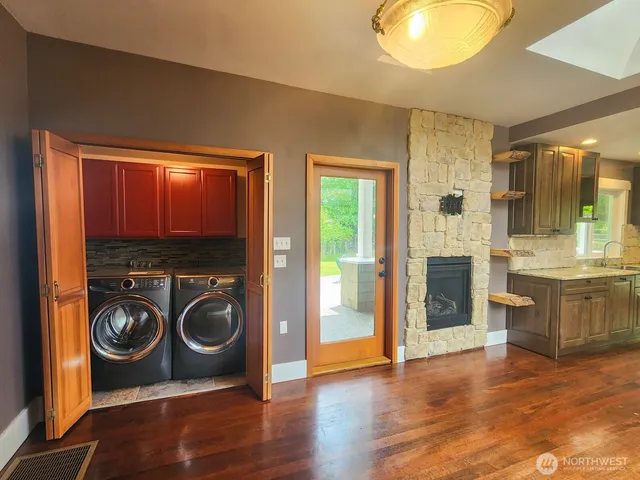 a view of a kitchen with a sink and a washer dryer