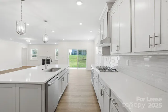 a kitchen with a sink stove and cabinets