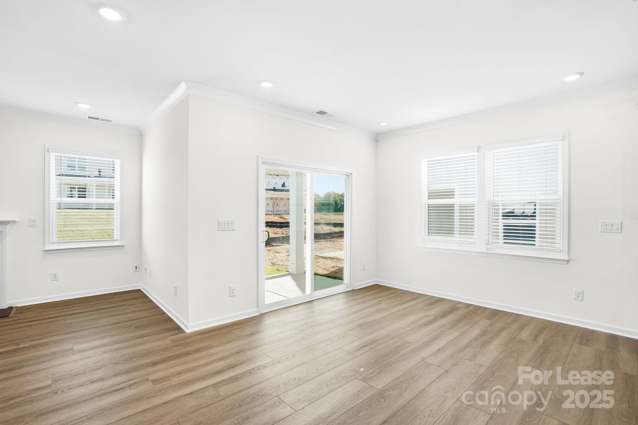 10205 Whitaker Pointe Drive Huntersville, NC 28078 - Photo 28 of 48 a view of an empty room with wooden floor and a window