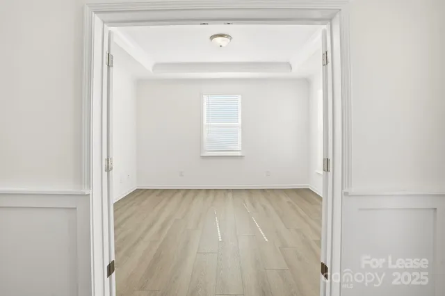 a view of a small space with wooden floor and a window