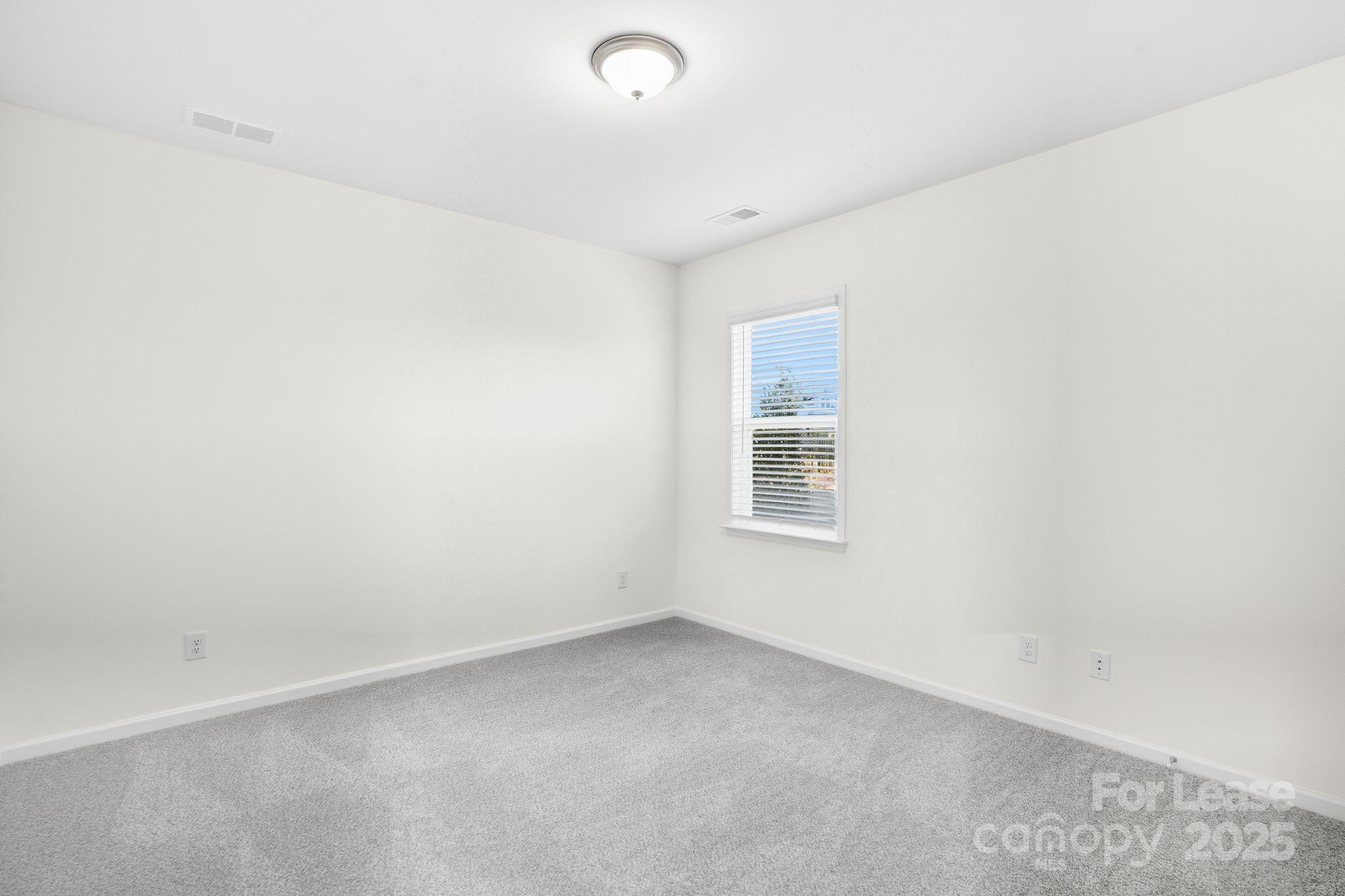 10205 Whitaker Pointe Drive Huntersville, NC 28078 - Photo 34 of 48 an empty room with a window