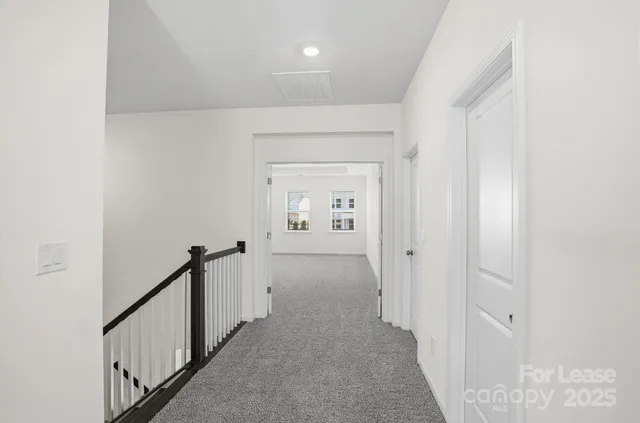 a view of a hallway view with wooden floor and staircase