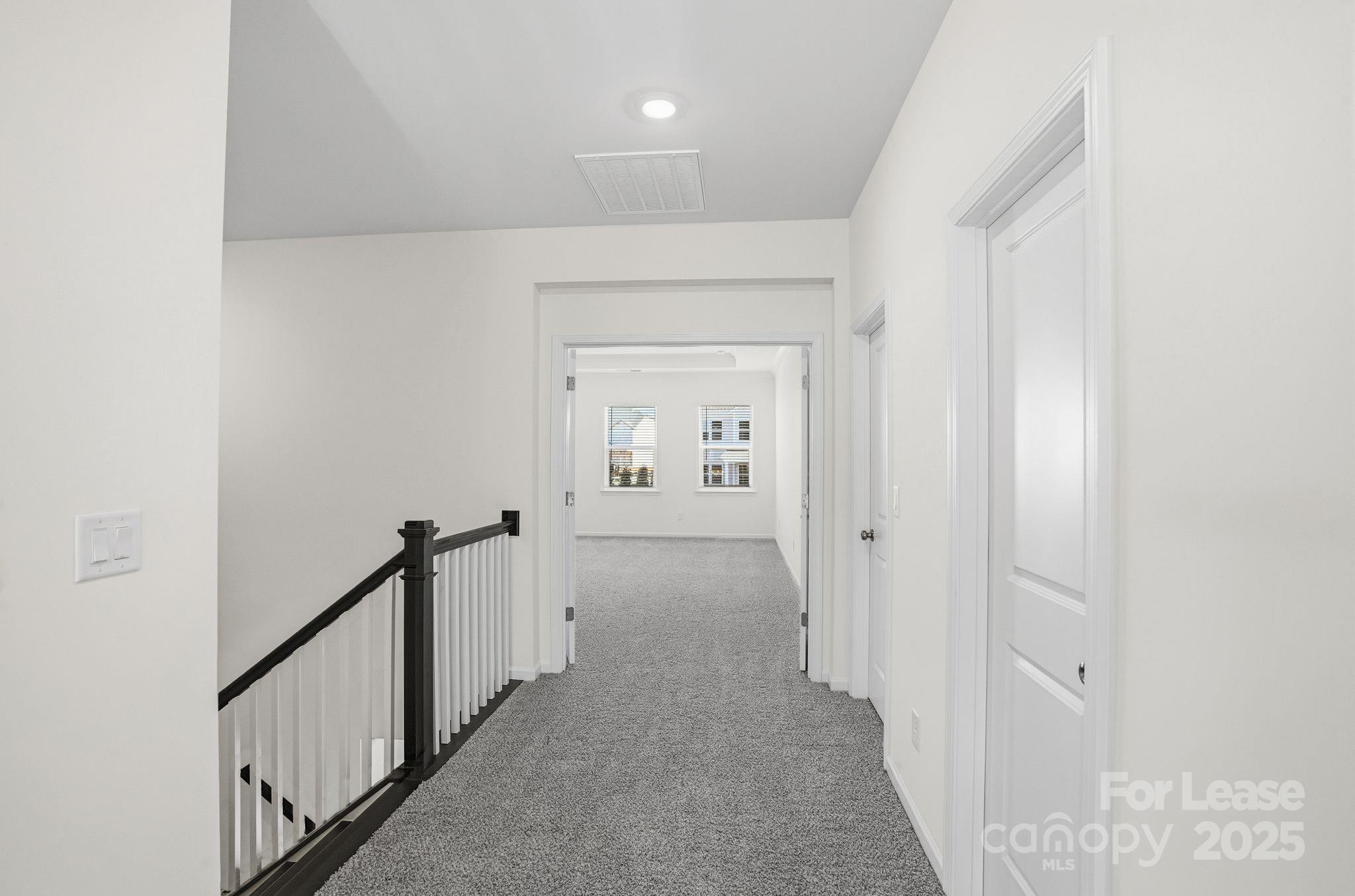 10205 Whitaker Pointe Drive Huntersville, NC 28078 - Photo 45 of 48 a view of a hallway view with wooden floor and staircase