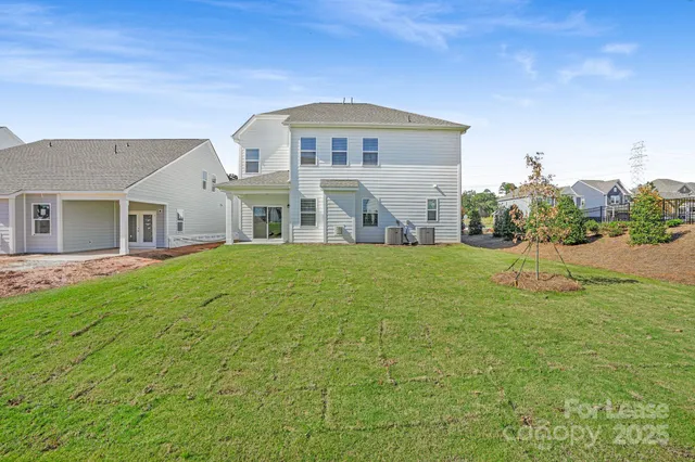 a view of a house with a backyard