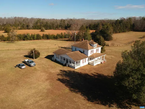 an aerial view of a house with a yard