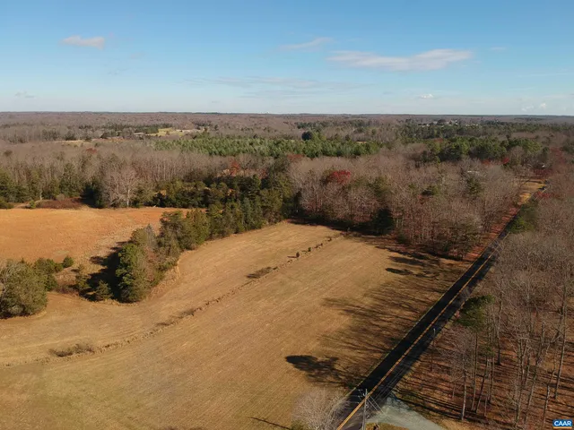 a view of a dry yard with wooden fence