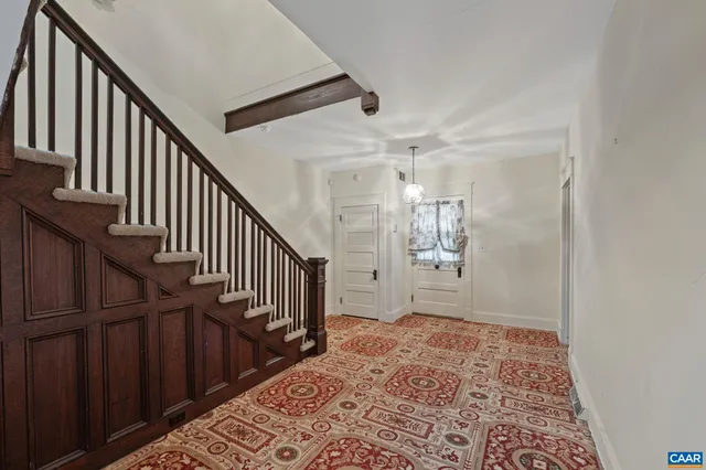 an empty room with sliding door and stairs
