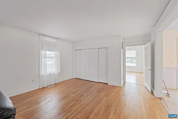 a view of empty room with a fireplace and ceiling fan